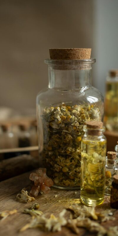 A rustic composition featuring vintage jars with dried herbs and essential oils, perfect for wellness themes.